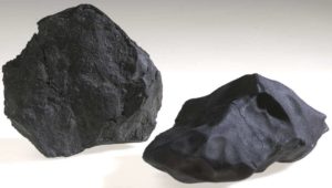 Two black chunks of meteorite.